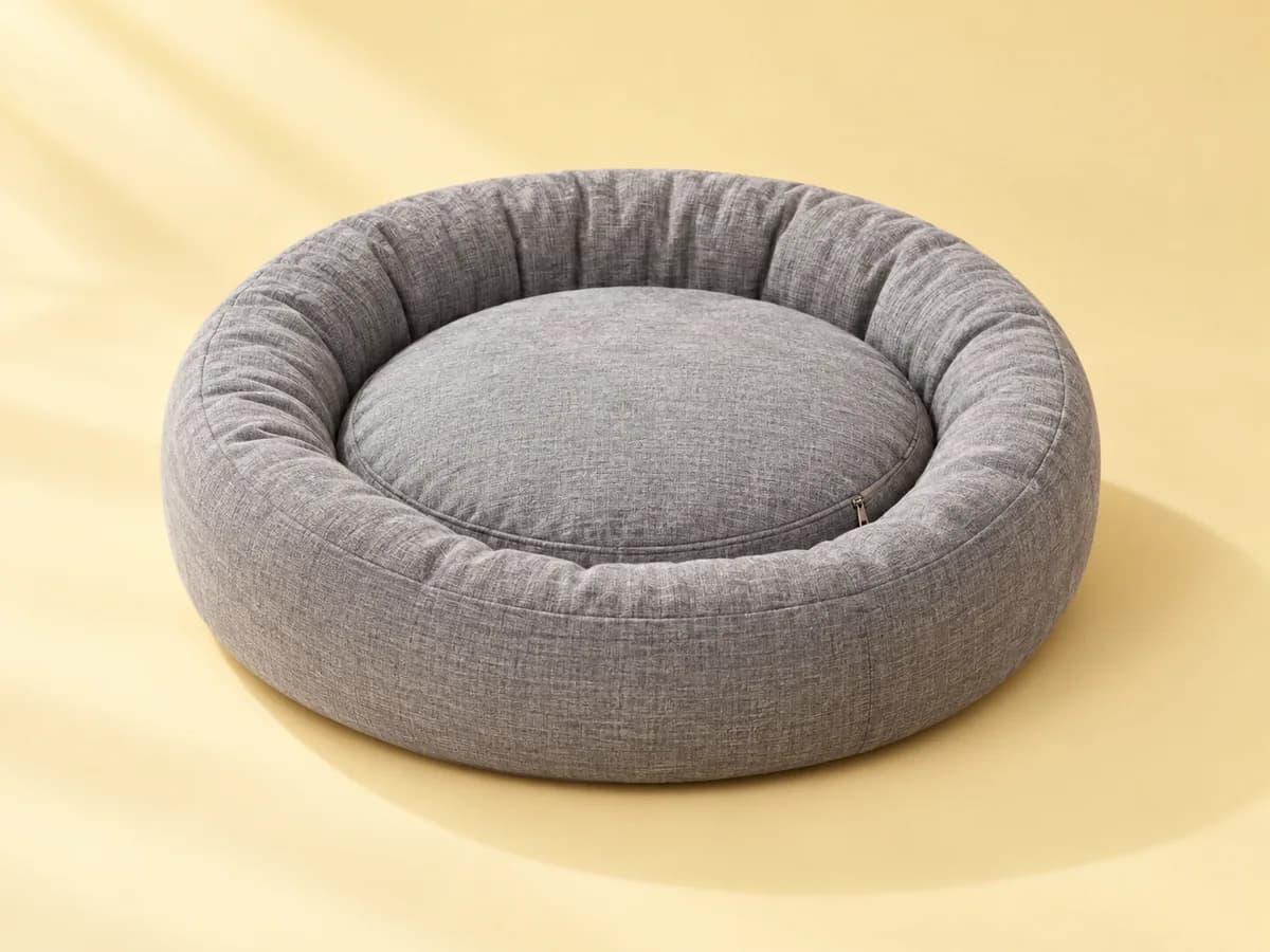 Round gray bolster dog bed with a raised rim and removable cushion