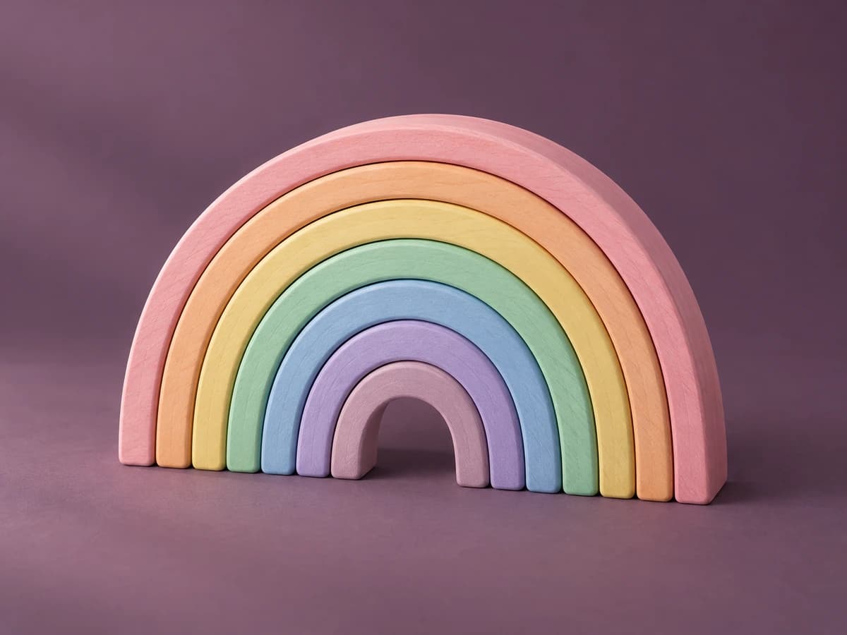 Wooden stacking rainbow of seven curved arches in pastel colors